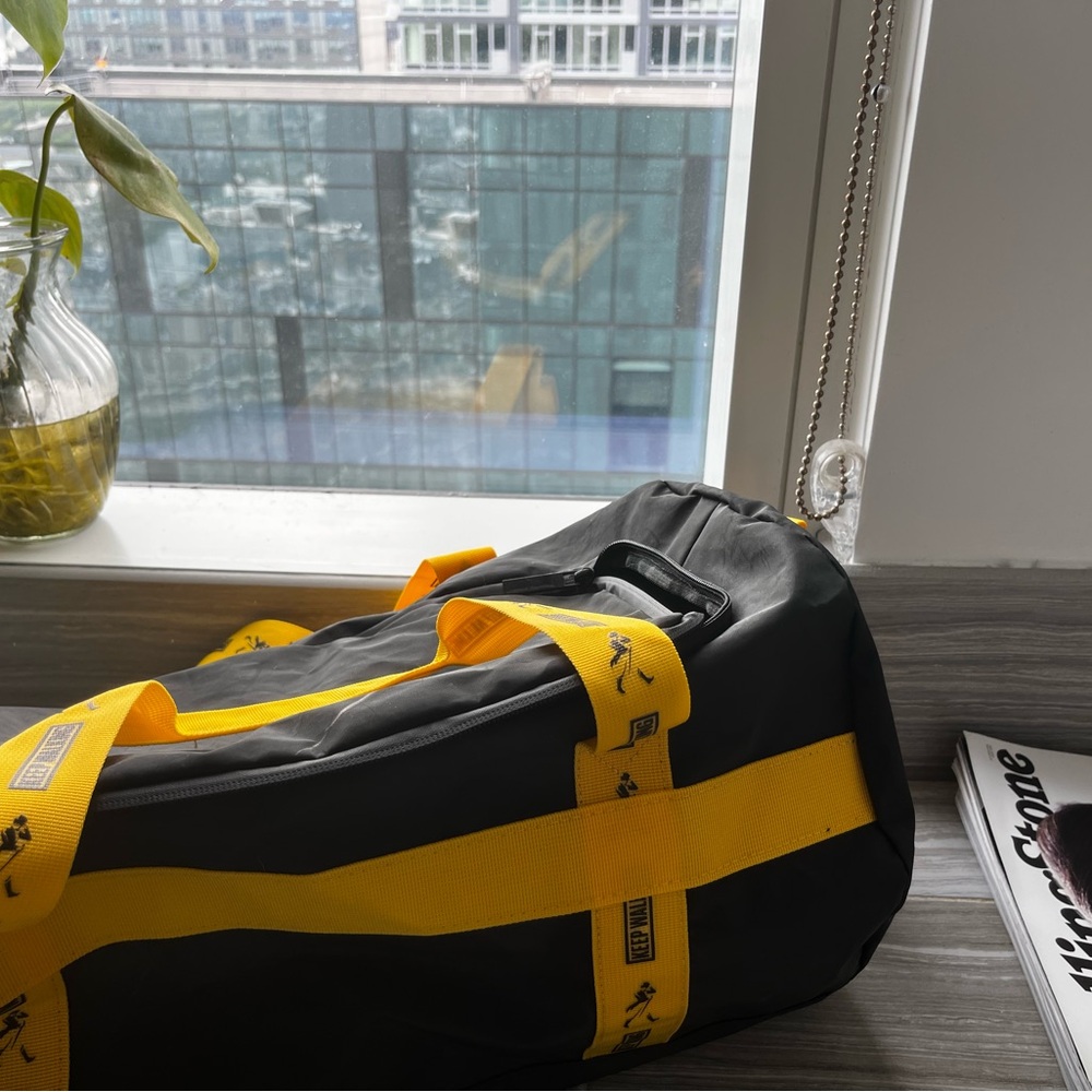 Sporty Black and Yellow Duffel Bag with Sturdy Design